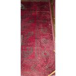 A Persian woollen red ground Bokhara rug, 220 x 133cm