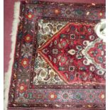 A Persian woollen red ground small Tabriz hall runner, 126 x 75cm