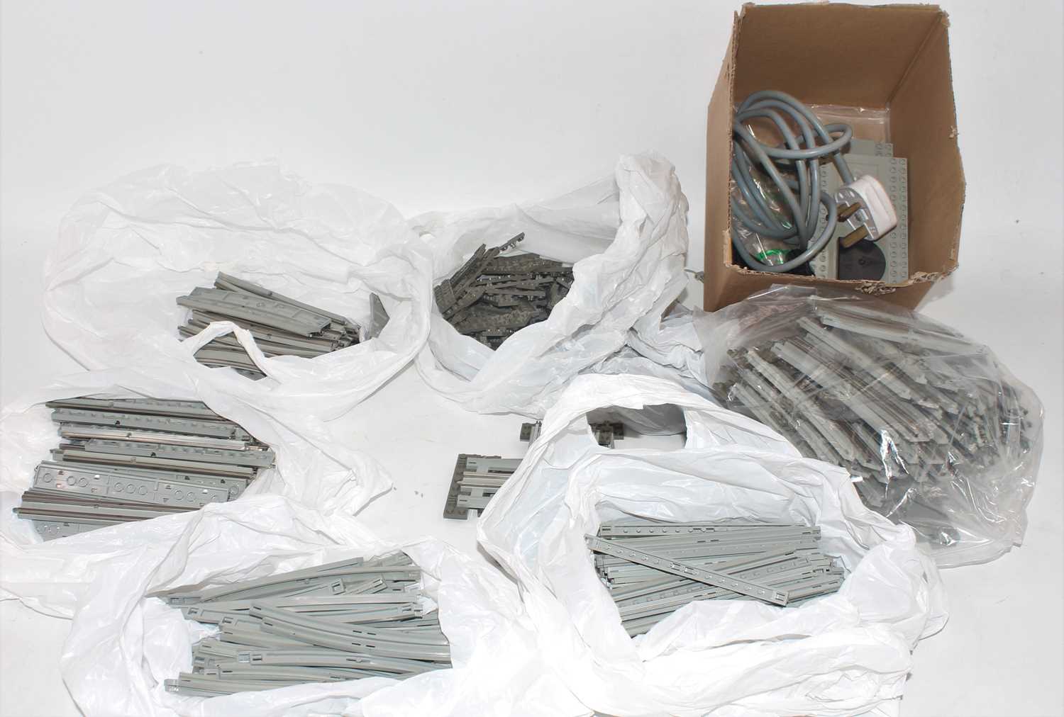 Two boxes containing a quantity of various vintage Lego 12 volt electric track and transformers,