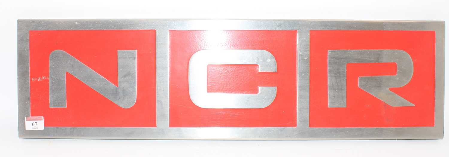 Late 20th century alloy "NCR" sign, red ground with silver lettering, measurements 70cm x 20cm