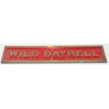 Brass sign to read "Wild Dayrell", red back ground, measurements 54cm x 11cm