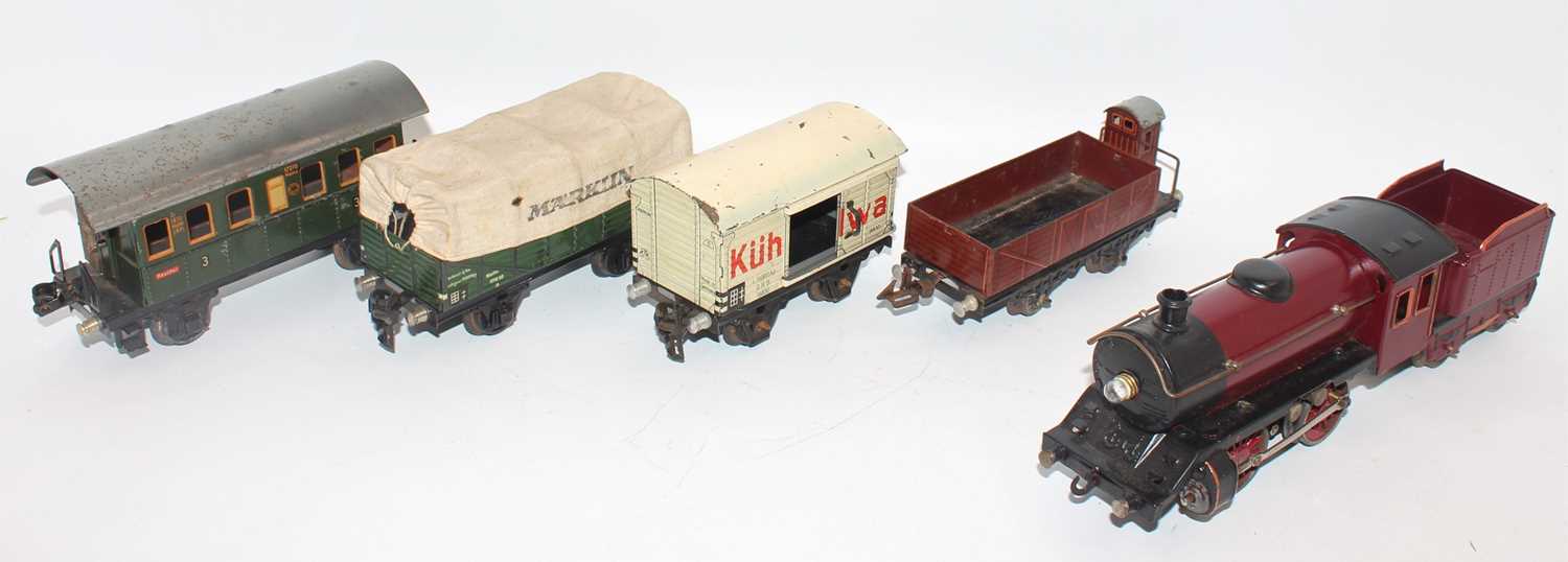 Tray containing Marklin items:- 0-4-0 loco and tender, electric motor, totally repainted dark red