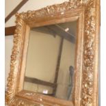 A composition framed wall mirror, being later spray-painted in gilt, 79 x 70cm