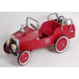 Modern release child's fire department pedal car finished in red and silver with red and white hubs.