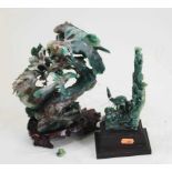 A Japanese carved green hardstone model of birds amongst flowers, on a carved hardwood base, h.26cm;