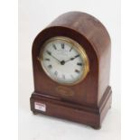 An early 20th century mahogany and boxwood strung mantel clock, the enamel dial showing Roman