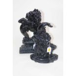 A cast iron doorstop in the form of Punch, h.32cm; together with one other in the form of a lion,