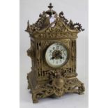 An early 20th century brass cased eight-day mantel clock, the enamelled chapter ring showing