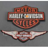 A cast iron Harley Davidson Motorcycles advertising sign, w.33cm; together with one other similar (