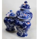 A garniture of three Chinese blue and white baluster jar and cover, in the Prunus pattern, with