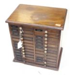 An early 20th century mahogany opticians table-top chest, containing two flights of twelve short