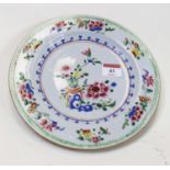 A Chinese export famille rose plate, decorated with flowers within a spearhead border, dia.23cm