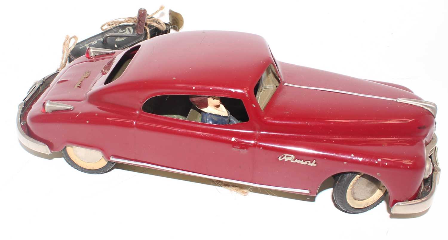 An Arnold tinplate and mechanical Primal Saloon comprising of maroon body with white wall tyres, - Image 2 of 2