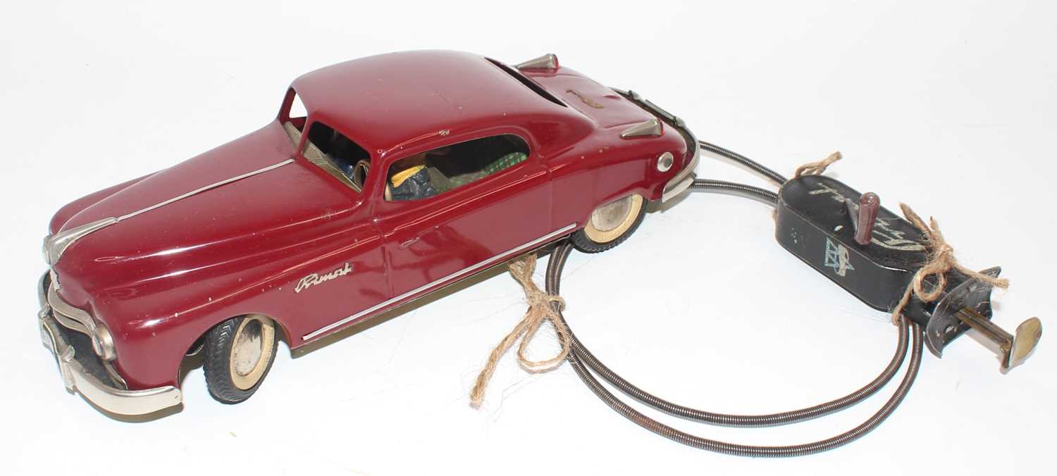 An Arnold tinplate and mechanical Primal Saloon comprising of maroon body with white wall tyres,