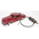 An Arnold tinplate and mechanical Primal Saloon comprising of maroon body with white wall tyres,