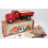 Gama No.501 battery operated and tinplate tipping truck, comprising red cab and back, black chassis,