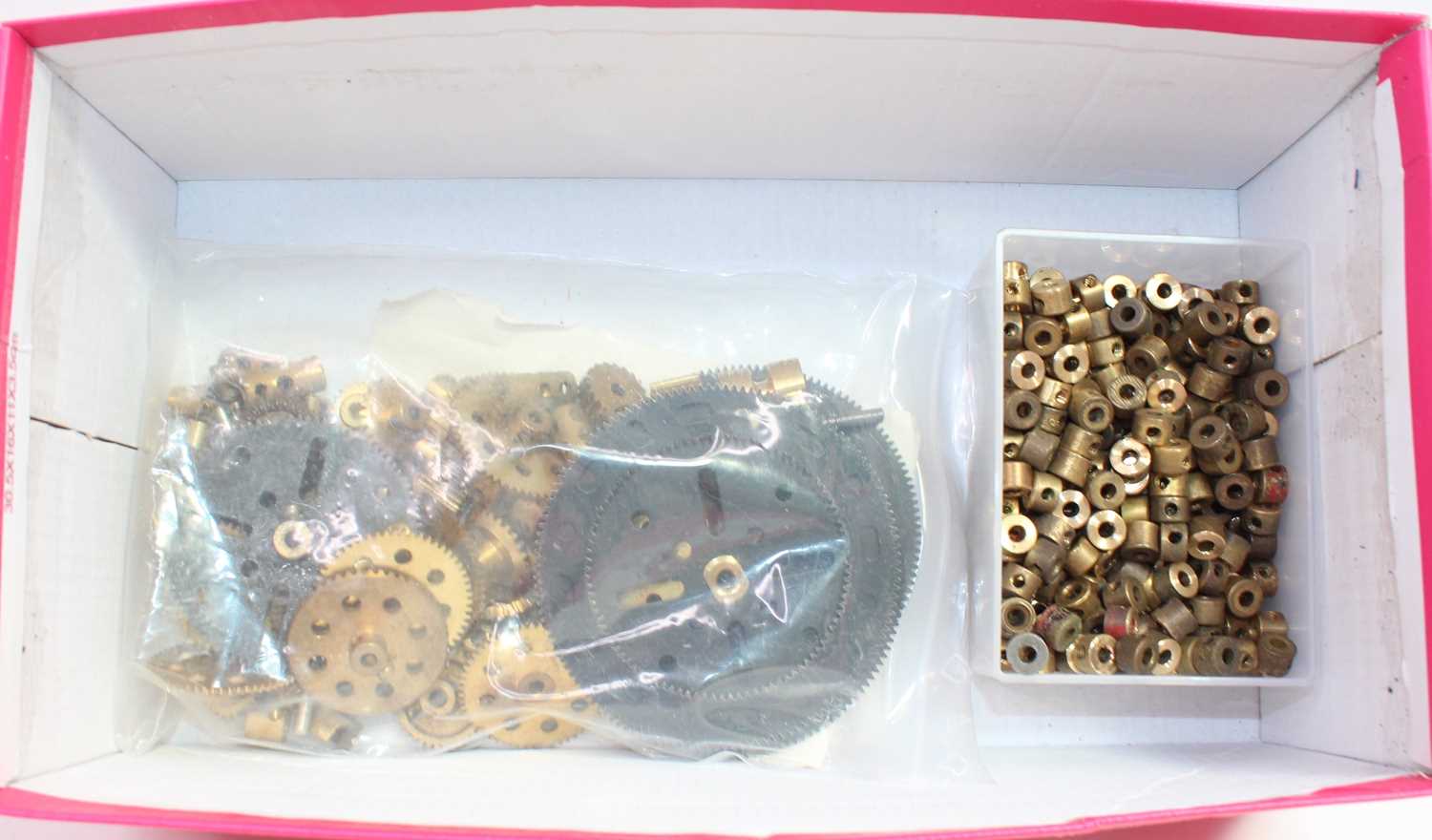 A quantity of Meccano brass components, to include cogs, wheels and pulleys, worm links, gears and