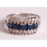 An 18ct white gold, sapphire and diamond three-row half eternity ring, featuring an inner row of