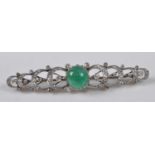 An early 20th century yellow and white metal, emerald and diamond bar brooch, featuring a round