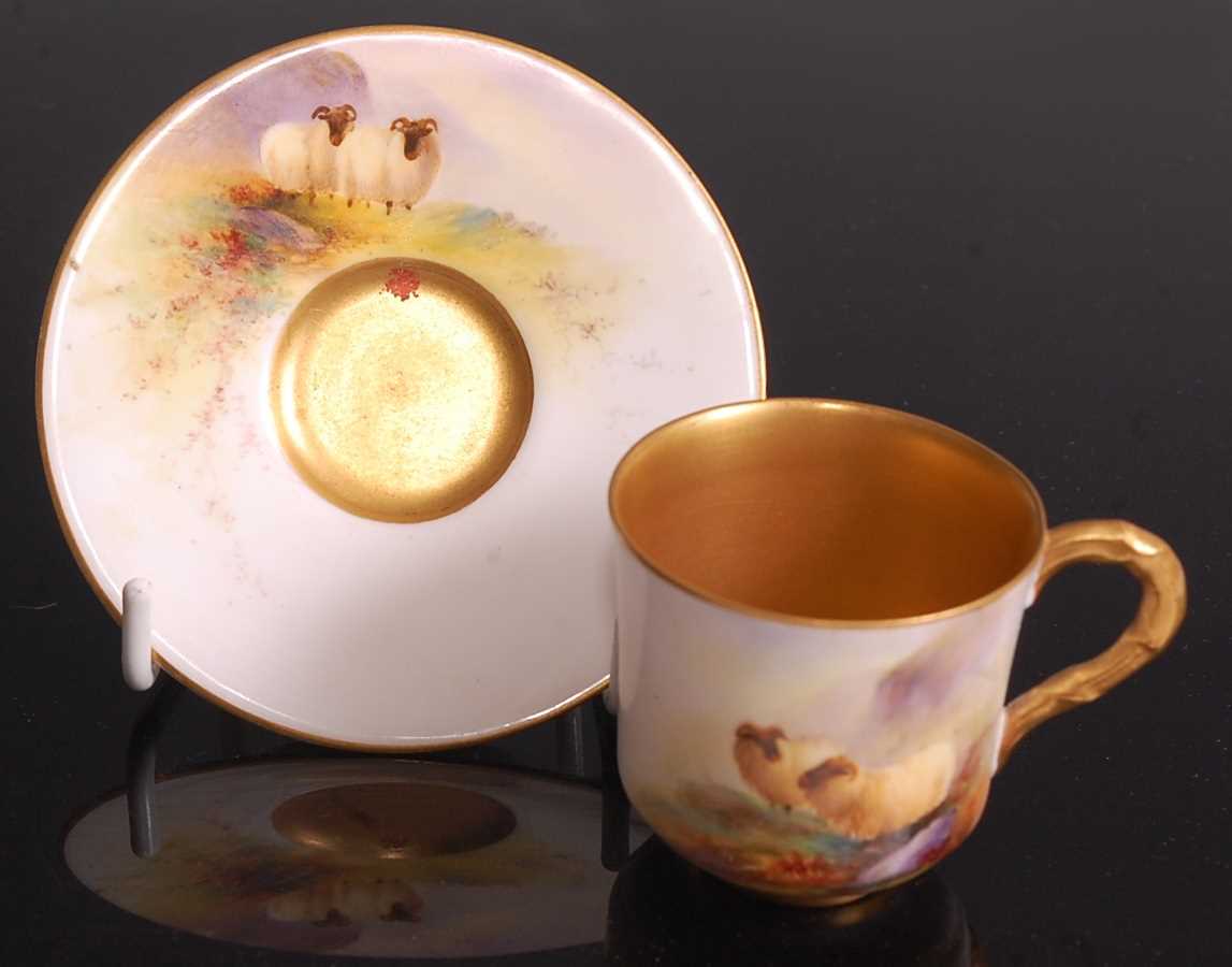 A Royal Worcester porcelain miniature cabinet cup and saucer, painted in polychrome enamels with two