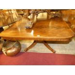 A Regency mahogany pedestal breakfast table, the rectangular tilt-top with rounded corners to a ring