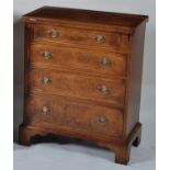 A walnut and figured walnut bachelors chest, in the early 18th century style, having a fold-over top