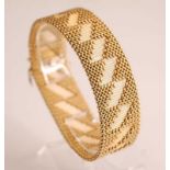 A yellow metal interwoven meshlink bracelet, having 18 diagonal bars with vertical line detail, with