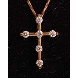 An 18ct yellow gold diamond set cross by Hearts on Fire fitted to a braided curblink chain, seven