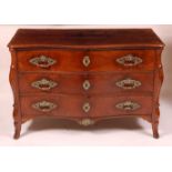 An 18th century French provincial walnut commode, having a serpentine front, three drawers each with