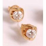 A pair of 18ct yellow gold single stone diamond earstuds, each with a round brilliant cut diamond