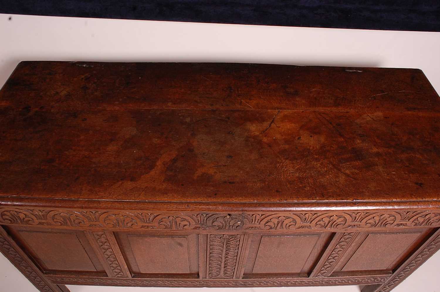 A circa 1700 joined oak four-panel coffer, the two plank top on original steel loop hinges, the - Image 2 of 7