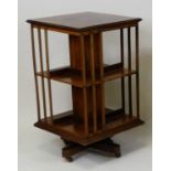 An Edwardian rosewood and marquetry inlaid revolving bookcase, of typical square section, w.51cm,