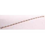 An 18ct white and rose gold diamond line bracelet, comprising seventeen fancy cognac diamonds in