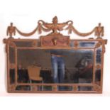 A circa 1900 gilt composition wall mirror in the Adam style, the pediment surmounted with urns and