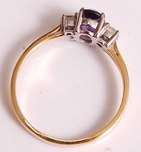 An 18ct yellow and white gold, amethyst and diamond three-stone ring, comprising a centre oval - Image 6 of 7