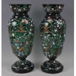 A pair of late Victorian green glass and carved pedestal vases, each of slender baluster form,