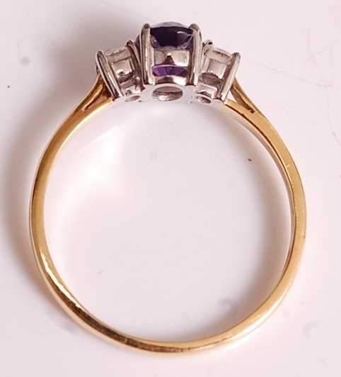 An 18ct yellow and white gold, amethyst and diamond three-stone ring, comprising a centre oval - Image 5 of 7