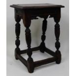 A circa 1700 oak joint stool, the one-piece top having a moulded edge over a shaped apron, on