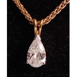 An 18ct yellow and white gold diamond single stone pendant, comprising a pear cut diamond in a