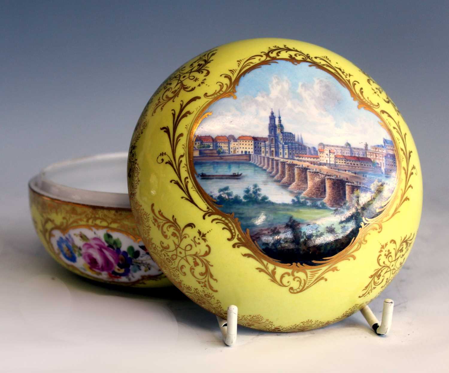 A late 19th century Meissen porcelain vanity pot and cover, the yellow ground richly decorated in