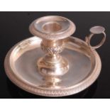 A late 19th century French silver chamberstick, of circular dished form with loop thumbpiece (
