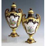 A pair of circa 1900 Royal Crown Derby pedestal urns with covers, each having ornate foot and