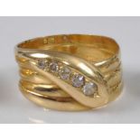 A late Victorian yellow metal snake ring, the head set with four graduated Old European cut diamonds