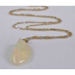 A yellow metal abstract hydrophane opal pendant, measuring approx 30 x 15mmn, attached to a yellow