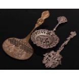 A late Victorian silver sifting spoon, the bowl having intricate pierced decoration with a bird to