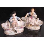 A pair of Meissen porcelain table salts, modelled as a man and a woman in 18th century dress, each