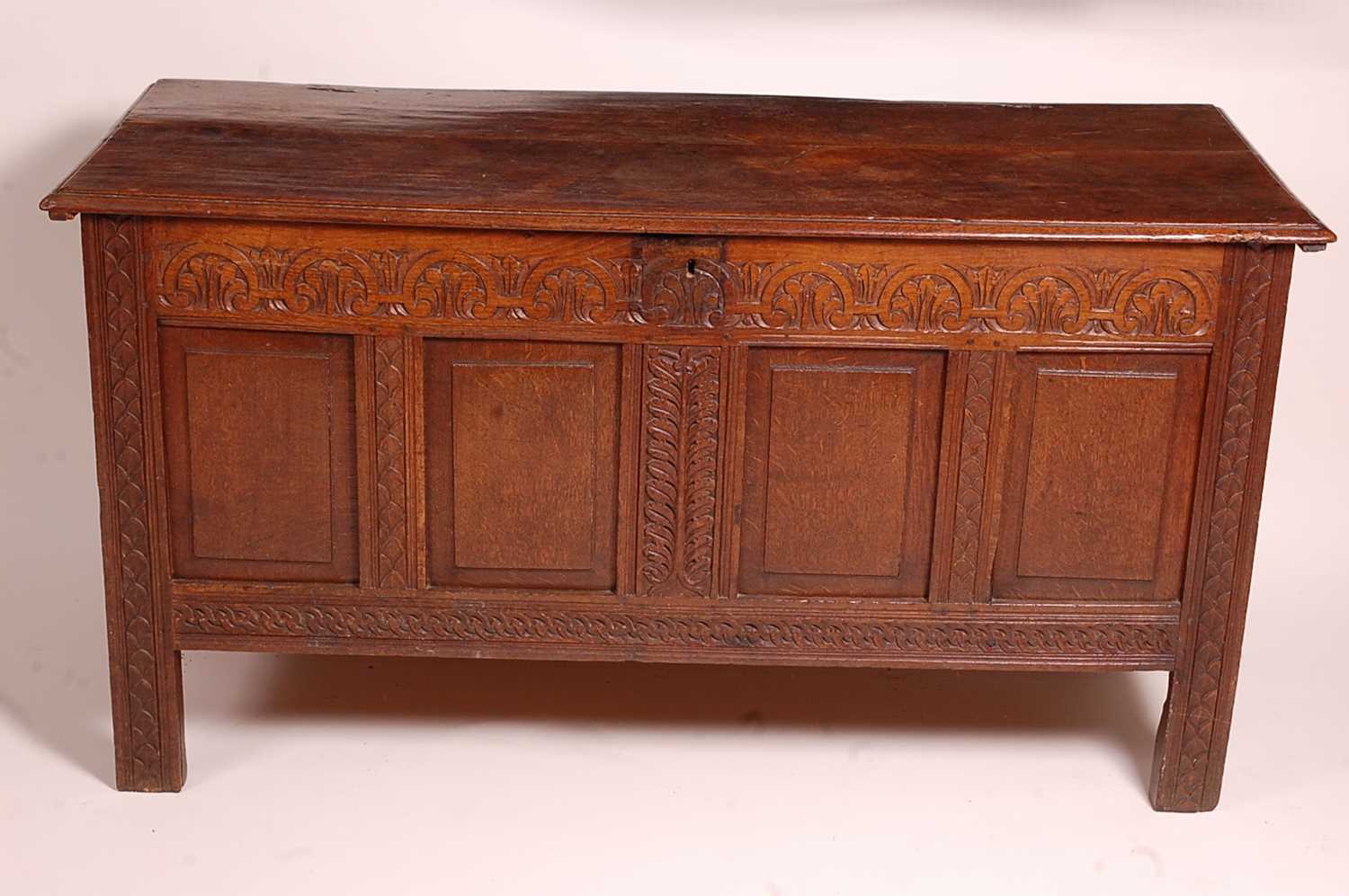 A circa 1700 joined oak four-panel coffer, the two plank top on original steel loop hinges, the