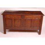 A circa 1700 joined oak four-panel coffer, the two plank top on original steel loop hinges, the