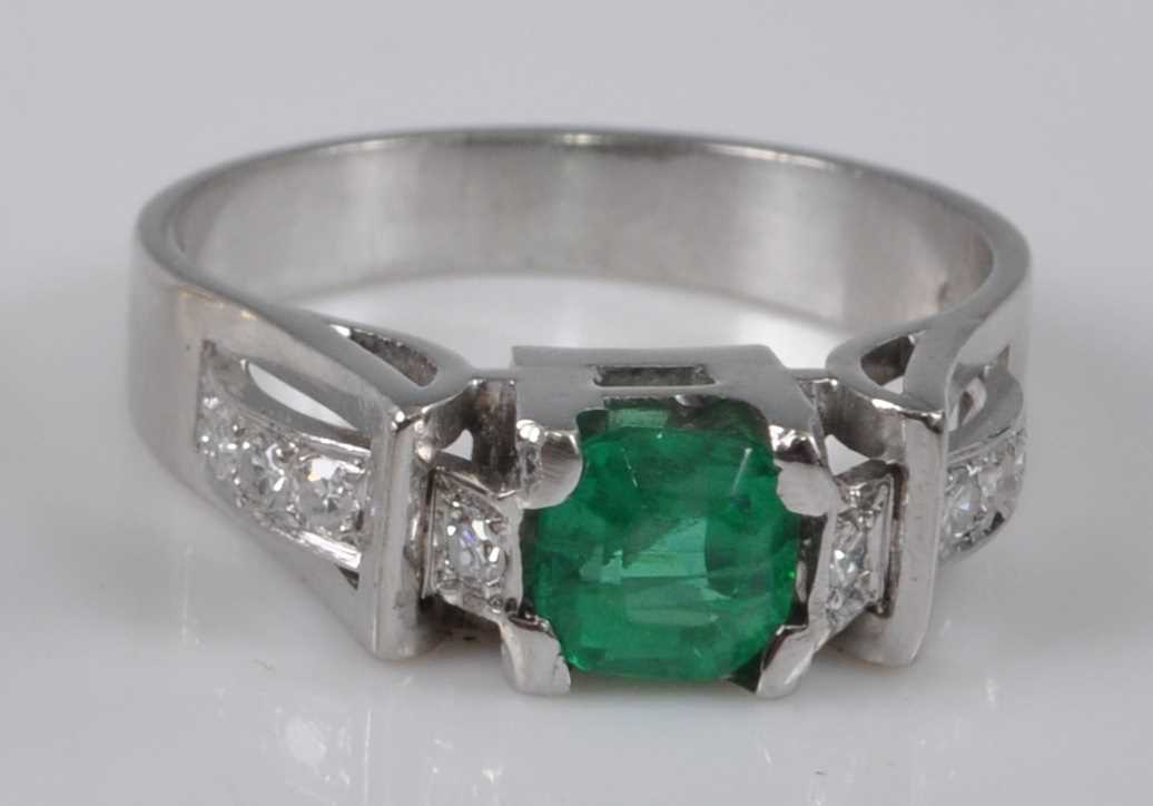 A white metal, synthetic emerald and diamond ring, comprising a centre octagonal cut synthetic