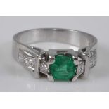 A white metal, synthetic emerald and diamond ring, comprising a centre octagonal cut synthetic